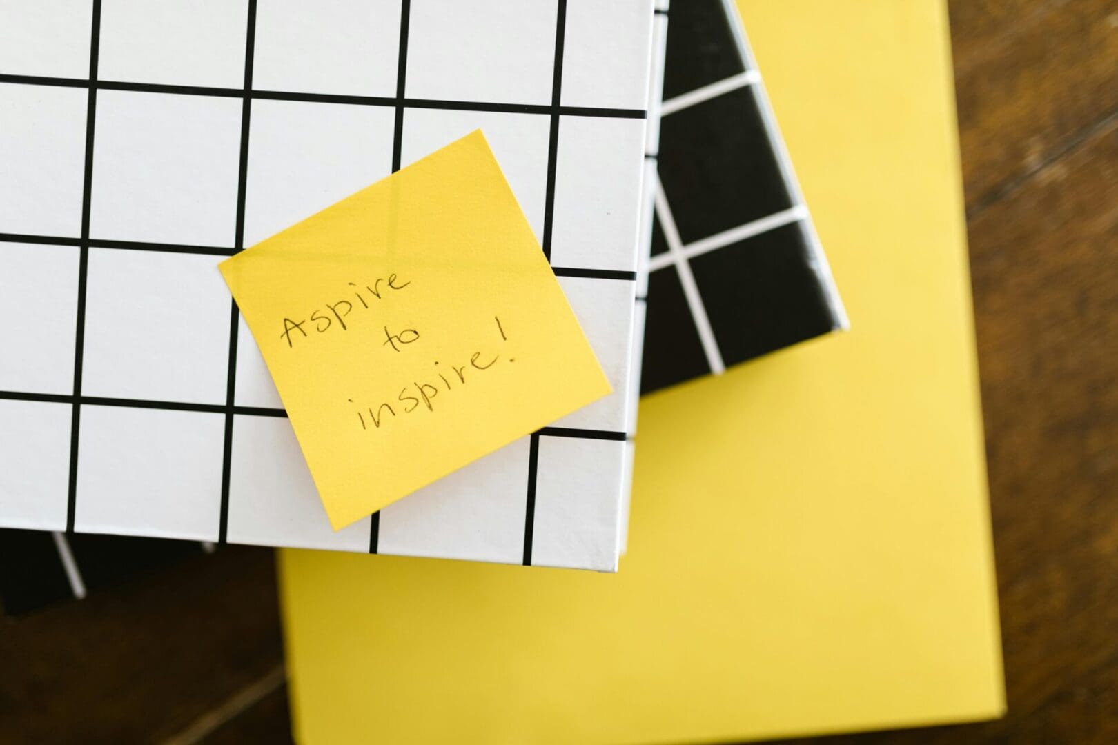 A yellow and white note sitting on top of a book.